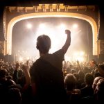 Audience punches the air at a Fontaines DC gig - by Jason Warner - Fyrefly Studios