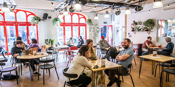 Old Fire Station cafe with people sitting on tables across the spac